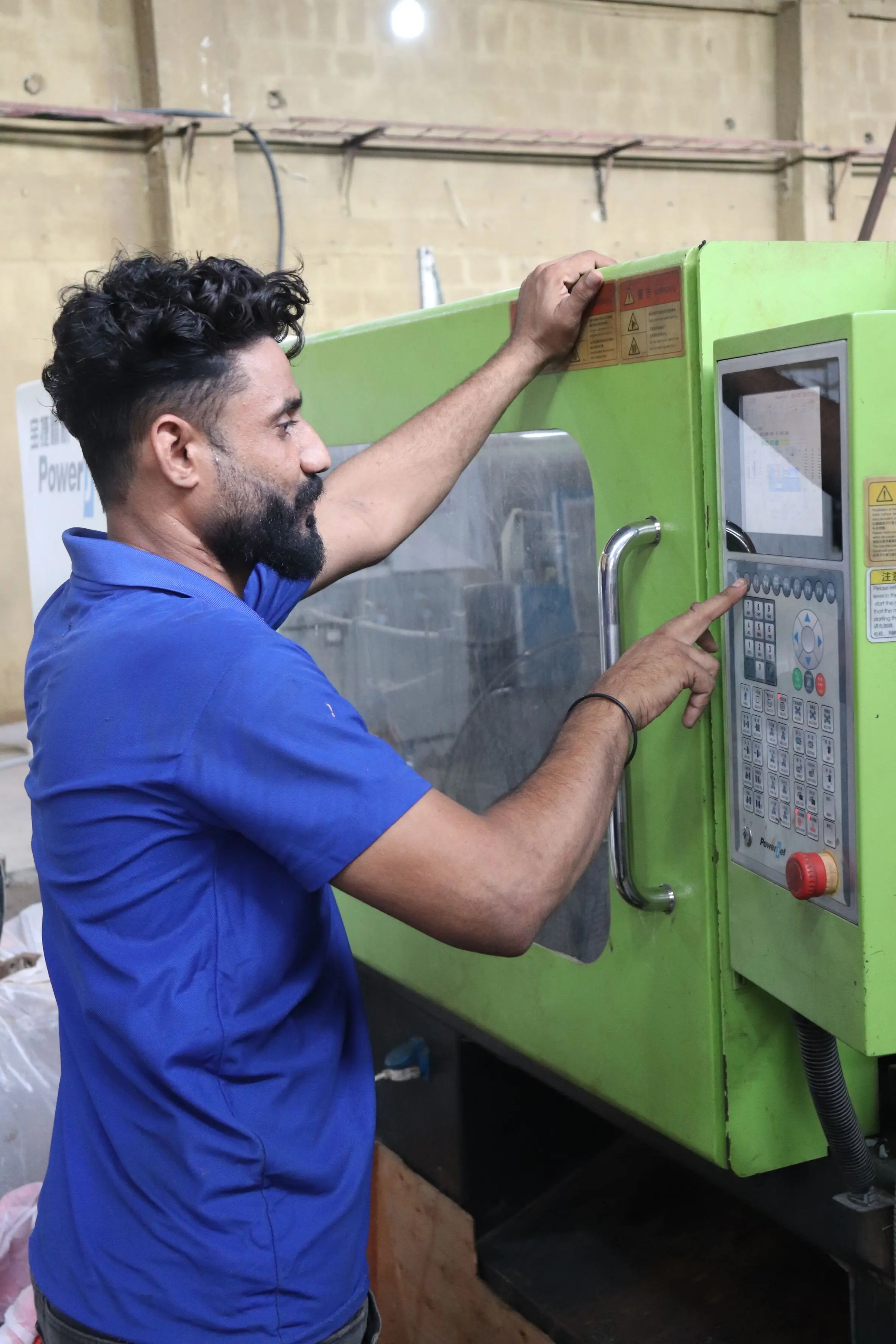 An operator setting a machine on a factory floor